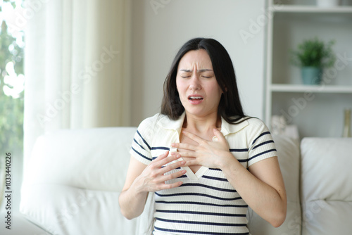 Asian woman chocking suffering asthma attack at home photo