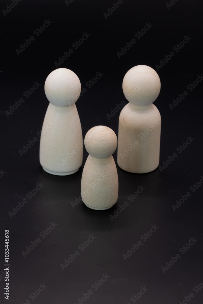 This captivating photo series uses minimalist wooden figures against a stark black backdrop to depict the dynamic nature of family. This captivating photo series uses minimalist wooden figures against a stark black backdrop to depict the dynamic nature of family.