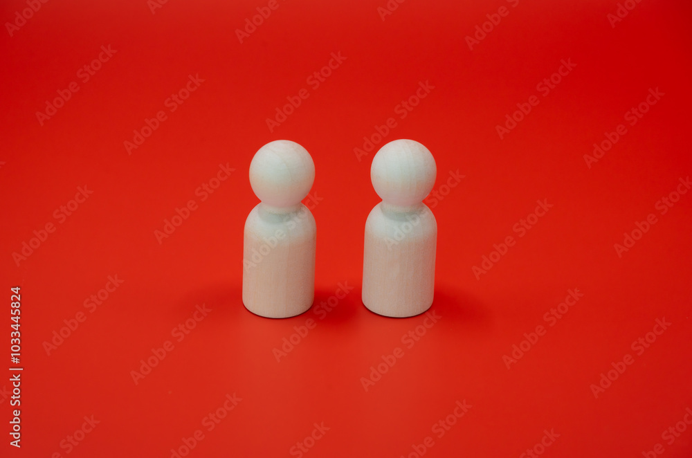 This series of four images captures the evolution of a family, symbolized by simple wooden figures against a vibrant red background. This series of four images captures the evolution of a family, symbolized by simple wooden figures against a vibrant red background.