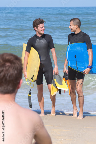 men boardboarders at the beach photo