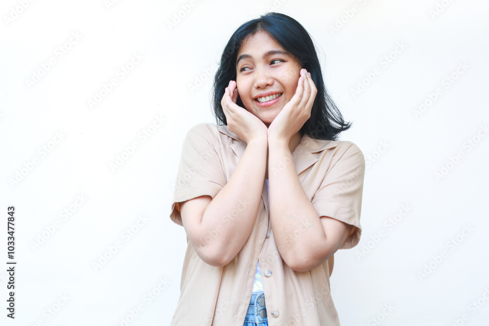 shocked asian woman touch her cheek with palm wearing casual brown clothes isolated on white background shocked asian woman touch her cheek with palm wearing casual brown clothes isolated on white background