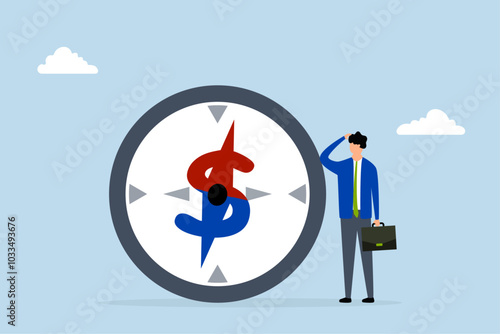 Economic direction or investment trend, Businessman investor examining compass pointing towards dollar sign direction.