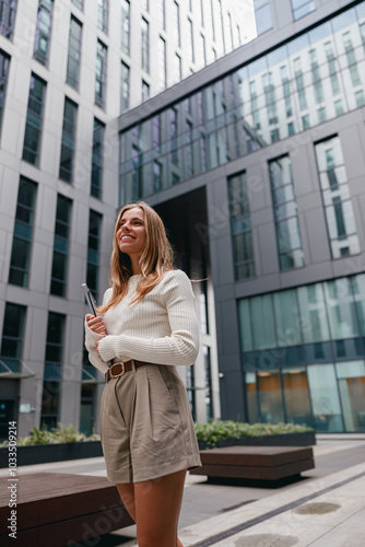 A Young Woman Standing in an Urban Environment Surrounded by Modern Architectural Elements