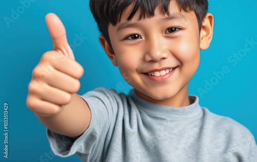 Smiling boy with thumbs up gesture