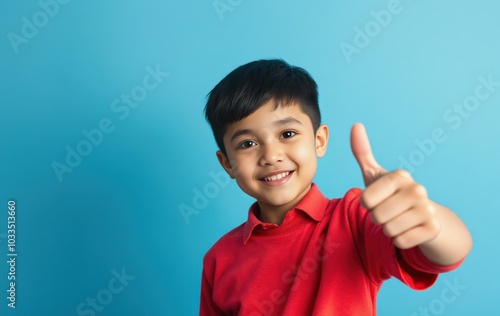 Smiling boy with thumbs up gesture