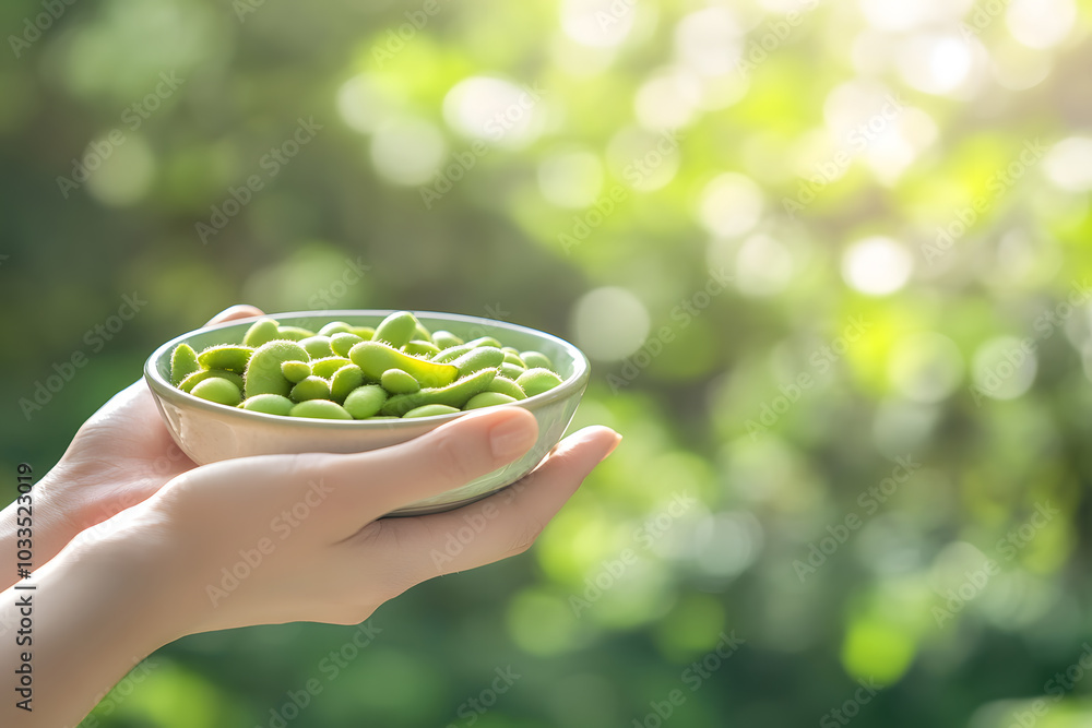 Bright green edamame beans overflowing from a small bowl held in hand, symbolizing health and freshness Bright green edamame beans overflowing from a small bowl held in hand, symbolizing health and freshness
