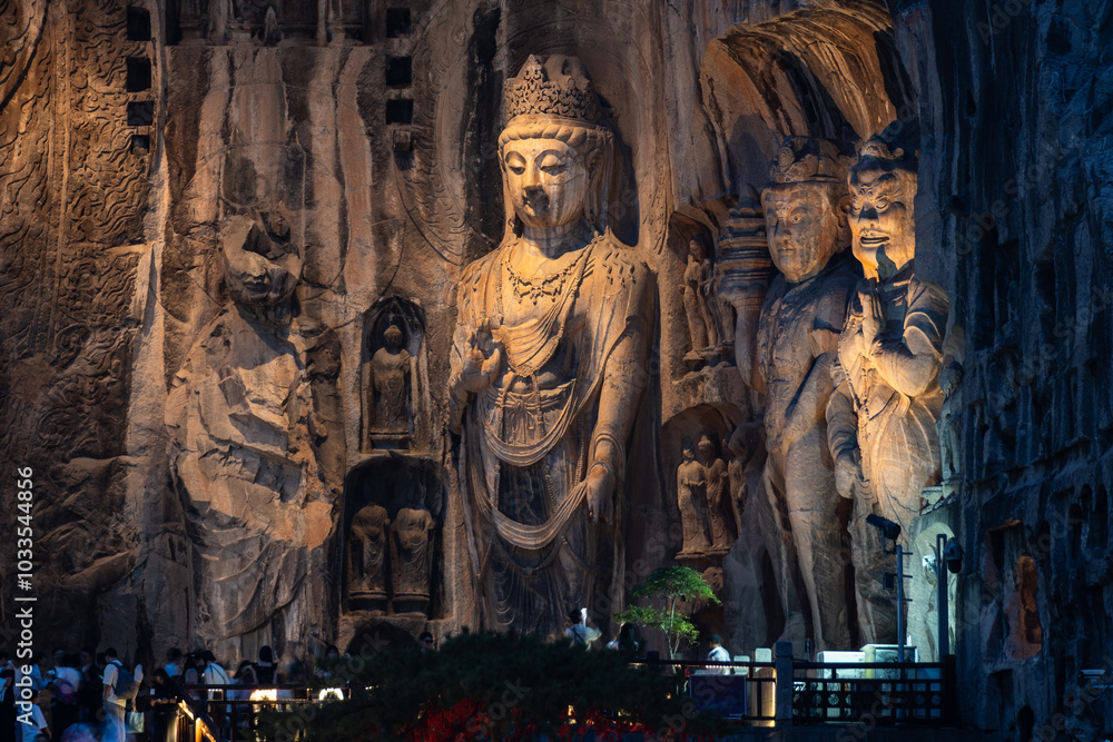 Luoyang, China: The famous Buddha statues at night in the Luoyang Longmen Grottoes in China. The statues dates from the 7th century and the Tang dynasty in Henan province