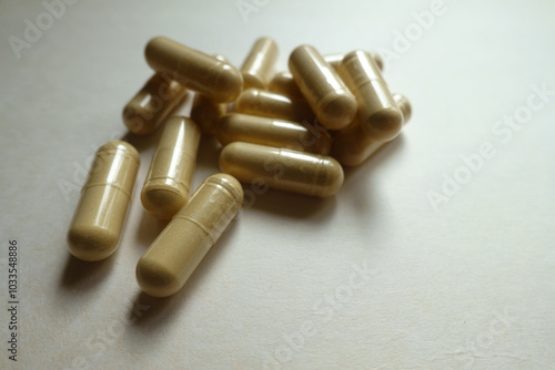 Closeup of handful of beige capsules of Saccharomyces boulardii probiotic dietary supplement photo