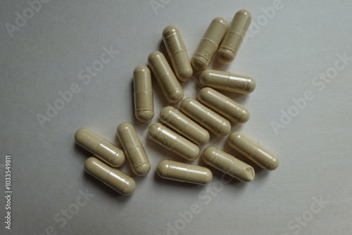 Top view of group of beige capsules of Saccharomyces boulardii probiotic dietary supplement photo