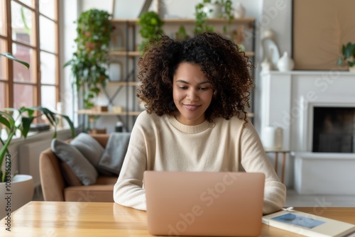 A woman working on her laptop in a bright and cozy home office, surrounded by plants, creating a calm and productive work environment.