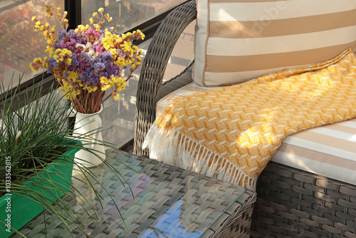 Fototapeta Naklejka Na Ścianę i Meble -  Wicker patio furniture and dry flowers on sunny autumn day in backyard. Garden furniture for relaxing. 