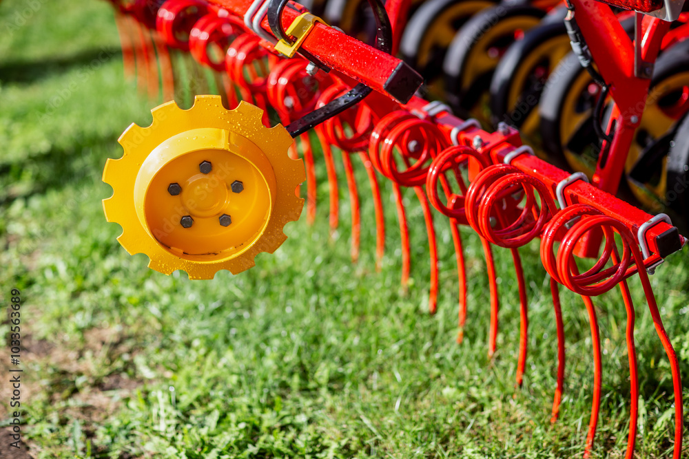 Fototapeta premium Red agriculture farming tractor for soil recurment close up of red parts of tractor