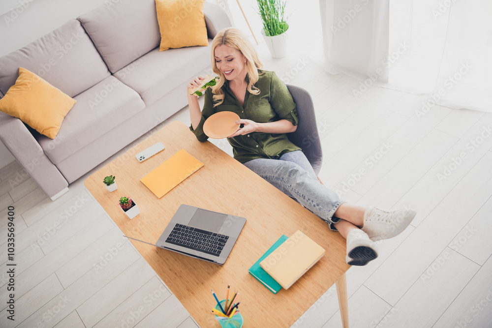 Top view photo of charming lovely woman assistant wear stylish shirt sit table work from home eat dinner indoors Top view photo of charming lovely woman assistant wear stylish shirt sit table work from home eat dinner indoors