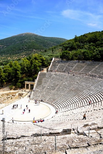 Panoramic view on a sunny summer day over the Ancient Theatre of Epidaurus in Greece, dedicated to the ancient Greek God of medicine, Asclepius. Holidays and sightseeing in Greece