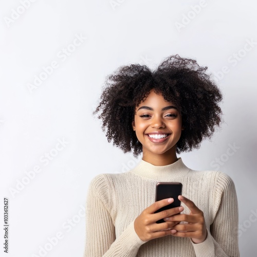 Smiling young black woman holding a phone hair background portrait.