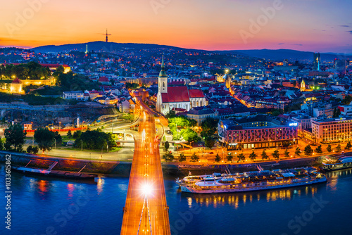 Bratislava, Slovakia - June 2022: City skyline on the shores of the Danube river; Bratislava castle, the old town, Eurovea; UFO bridge; SNP bridge; Apollo Bridge