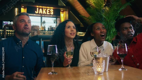 A group of friends celebrating while watching a football match