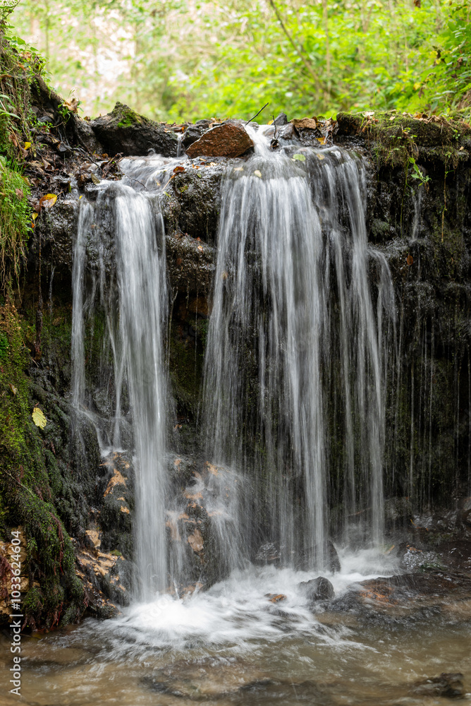 beautiful horizontal photo of a waterfall with lush green forest in the background beautiful horizontal photo of a waterfall with lush green forest in the background