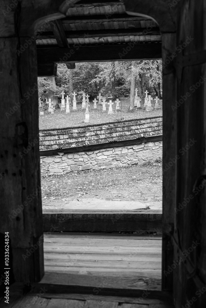Obraz premium old white crosses and tombstones in a rundown forgotten cemetery in Poland