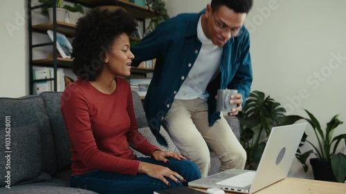 African American university student showing her boyfriend her school essay photo