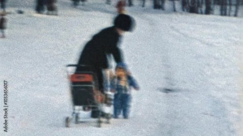 Small child with mother resting in winter snowy park. Family leisure in snow forest nature. Parent walking little baby. Cozy motherhood. Casual lifestyle. Vintage film. Christmas archive. Retro 1980s
