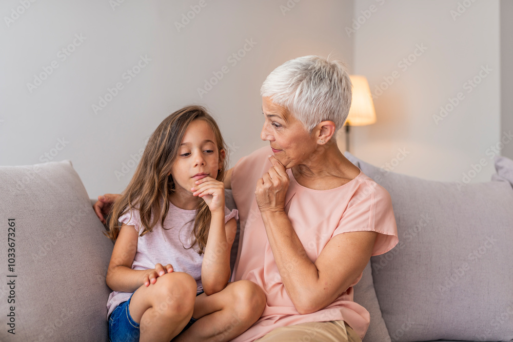 Grandmother and Granddaughter Sharing a Thoughtful Moment at Home Grandmother and Granddaughter Sharing a Thoughtful Moment at Home