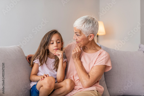 Grandmother and Granddaughter Sharing a Thoughtful Moment at Home