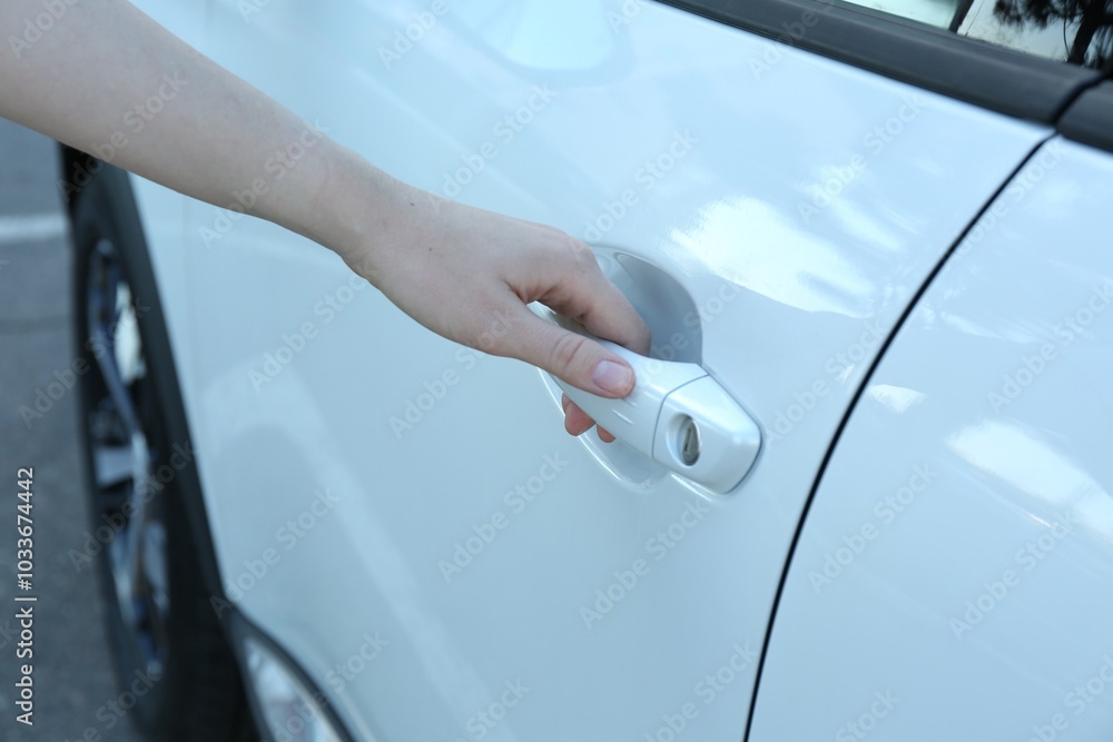 Woman opening door of white car outdoors, closeup Woman opening door of white car outdoors, closeup