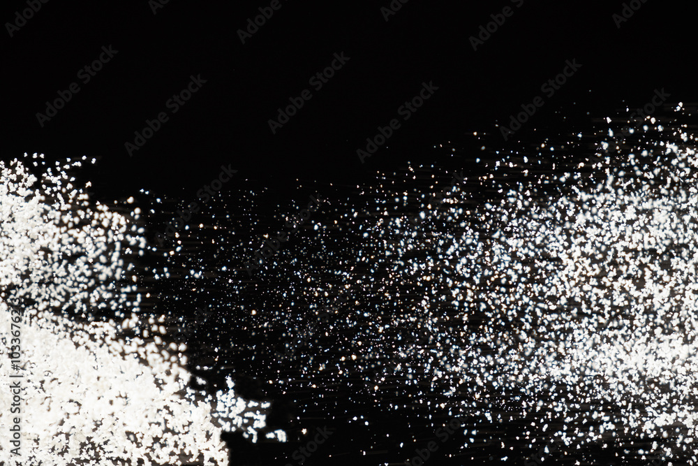 Obraz premium Abstract black and white background of pouring flour, space for text