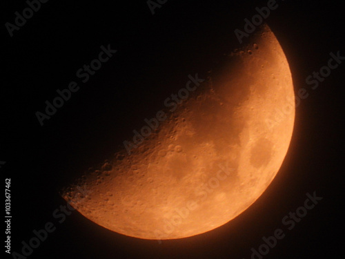 moon in the first quarter phase seen through the mist