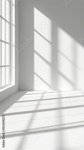 Sunlight streaming through large windows casts dramatic shadows on pristine white walls, creating a serene and minimalist interior space with geometric patterns.