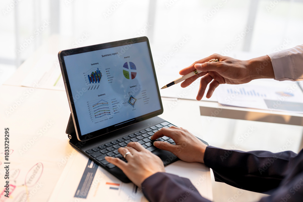 A person is typing on a laptop with a picture of a pie chart on the screen A person is typing on a laptop with a picture of a pie chart on the screen