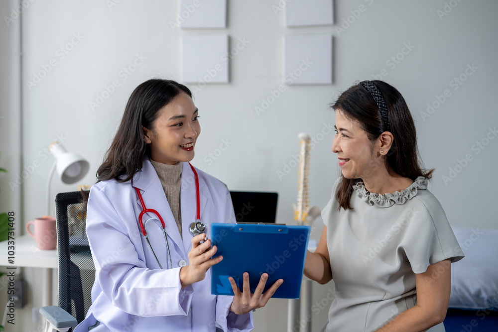 Female doctor showing clipboard to her patient during medical consultation in clinic Female doctor showing clipboard to her patient during medical consultation in clinic