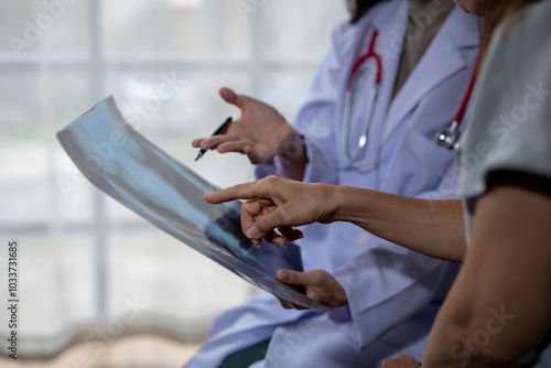 Two female doctors discussing about a radiography in a hospital room