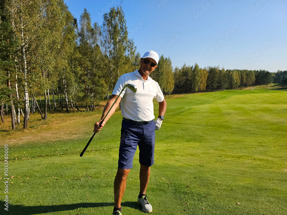 Golfer poses confidently on a lush green course surrounded by trees on a sunny day Golfer poses confidently on a lush green course surrounded by trees on a sunny day
