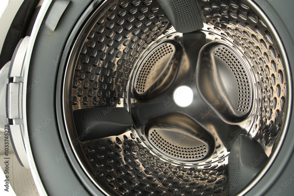 Washing machine with empty drum as background, closeup Washing machine with empty drum as background, closeup