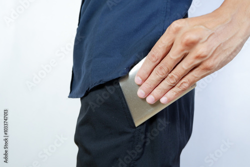 put the smartphone in trouser pocket. close-up photo of straying smartphone into trouser pocket