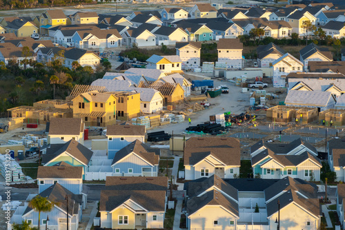 Aerial view of unfinished wooden frames of affordable houses under construction. Development of residential housing in American suburbs. Real estate market in the USA photo