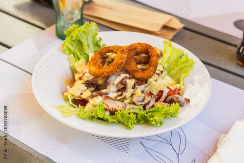 Delicious Salad With Chicken and Crispy Onion Rings photo