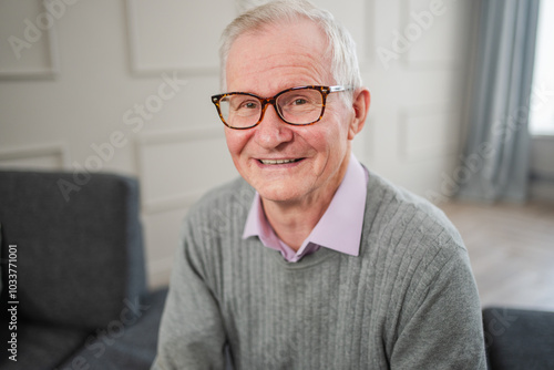 Portrait of confident stylish European middle aged senior man at home. Older mature 70s man smiling. Happy attractive senior grandfather looking camera close up face headshot portrait. Happy people photo