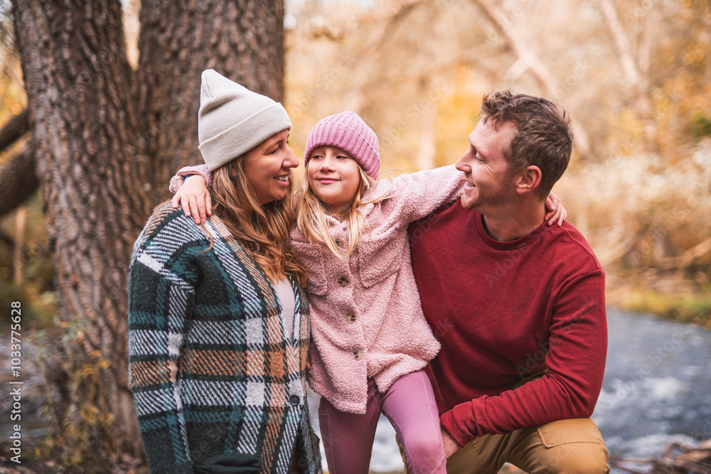 Fototapeta premium Joyful family and his little child girl have fun outdoors at autumn park.