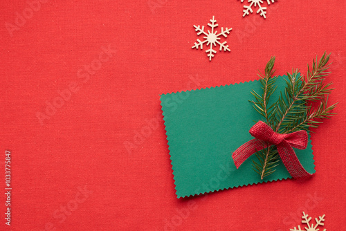 Christmas green greeting card mockup with eco-friendly xmas decorations on a red textile background, eco Christmas holiday concept, eco decor banner