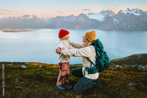 Child playing with mother family hike in mountains outdoor activity, travel together in Norway healthy lifestyle vacations, woman with kid exploring Lyngen Alps candid emotions, Mothers day