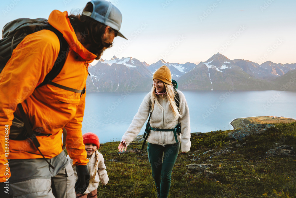 © EVERST - Family hiking together active travel lifestyle - mother, father, and child in mountains adventure tour in Norway, parents and kid on summer vacations outdoor, healthy lifestyle tourism, happy moments