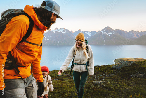 Family hiking together active travel lifestyle - mother, father, and child in mountains adventure tour in Norway, parents and kid on summer vacations outdoor, healthy lifestyle tourism, happy moments