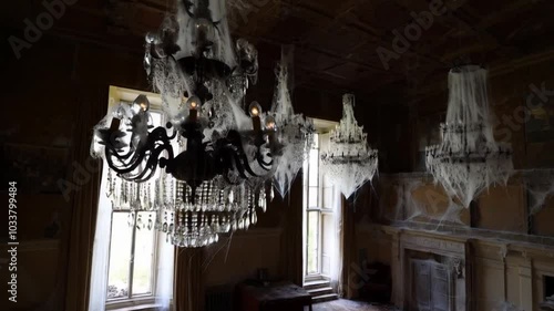 Cobweb-covered chandeliers hang in an old mansion’s grand hall, swaying gently. Echoes of distant laughter send chills down your spine.