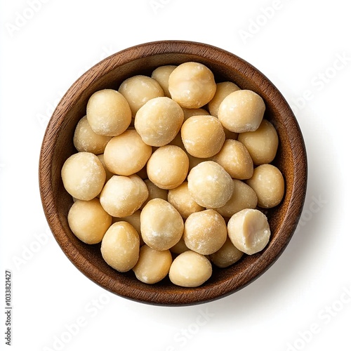 Top view of a wooden bowl filled with macadamia nuts isolated on white background