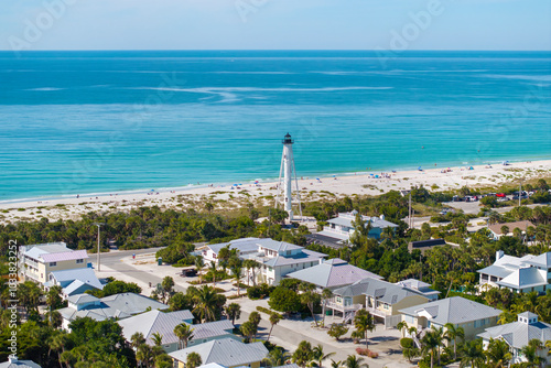 White lighthouse on sea shore for commercial vessels navigation at wealthy waterfront neighborhood in island small town Boca Grande on Gasparilla Island in southwest Florida, USA photo