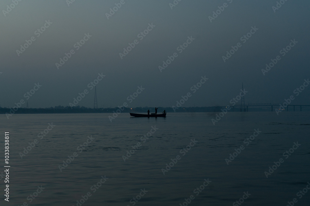 A serene scene of a boat sailing on calm waters at dusk. A serene scene of a boat sailing on calm waters at dusk.