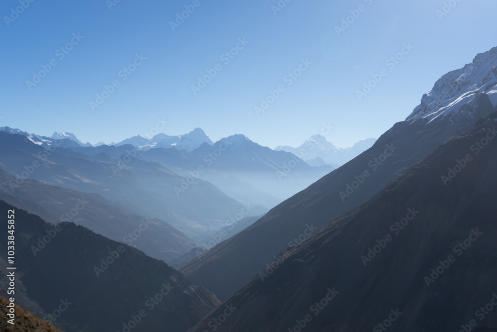 A breathtaking view of majestic mountains under a clear blue sky. A breathtaking view of majestic mountains under a clear blue sky.